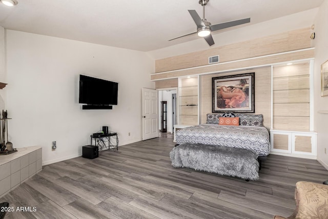 bedroom featuring dark wood finished floors, lofted ceiling, visible vents, ceiling fan, and baseboards