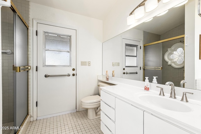 bathroom featuring a stall shower, vanity, toilet, and tile patterned floors