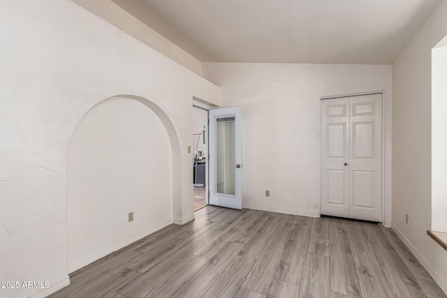 interior space featuring baseboards and wood finished floors