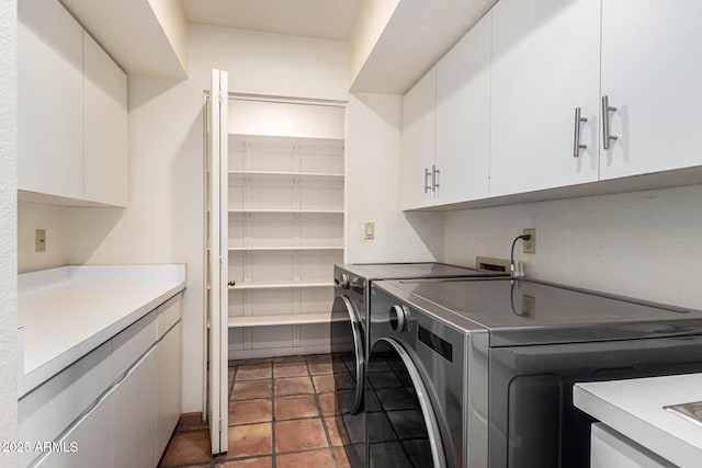 clothes washing area featuring cabinet space and washing machine and clothes dryer