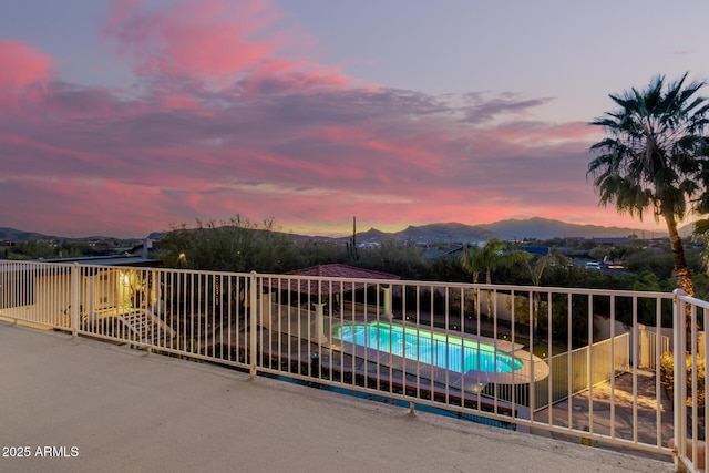 view of swimming pool featuring fence, a mountain view, and a fenced in pool