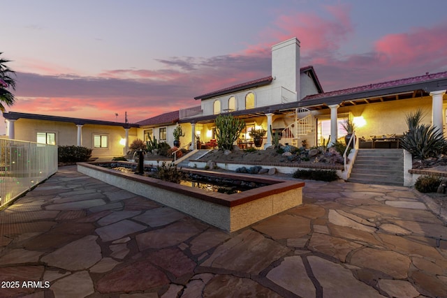 patio terrace at dusk with stairs and fence