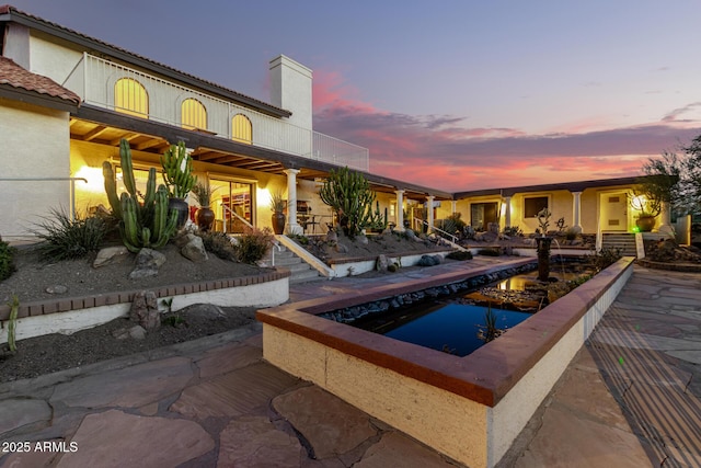 view of pool at dusk