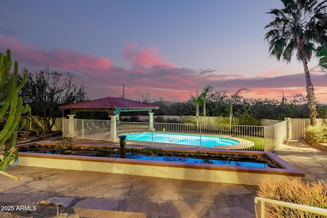 view of pool with fence, a fenced in pool, and a gazebo