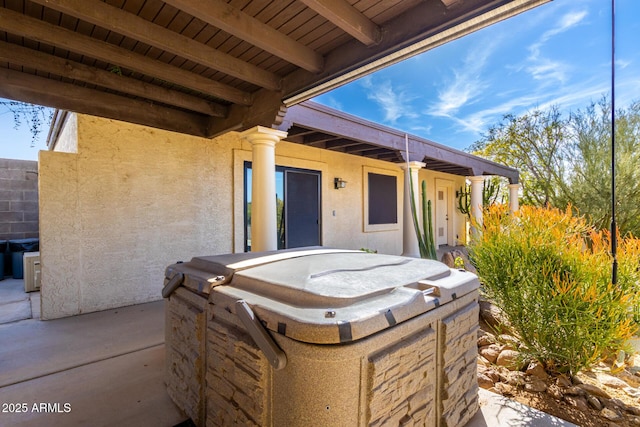 view of patio with a hot tub