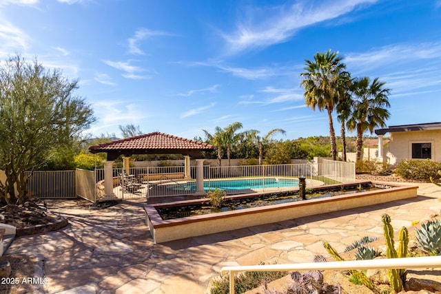 view of swimming pool with a patio area, fence, a fenced in pool, and a gazebo