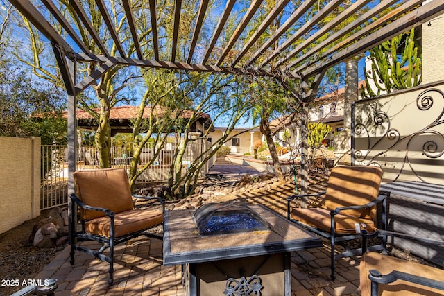 view of patio with an outdoor fire pit, fence, and a pergola