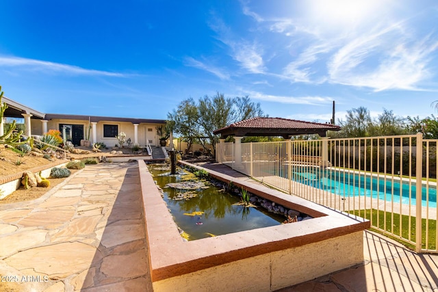 view of swimming pool featuring a fenced in pool, fence, and a gazebo