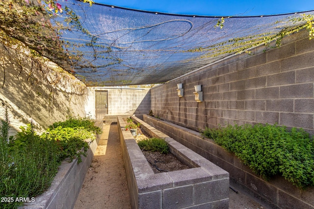 view of yard featuring a fenced backyard and a vegetable garden