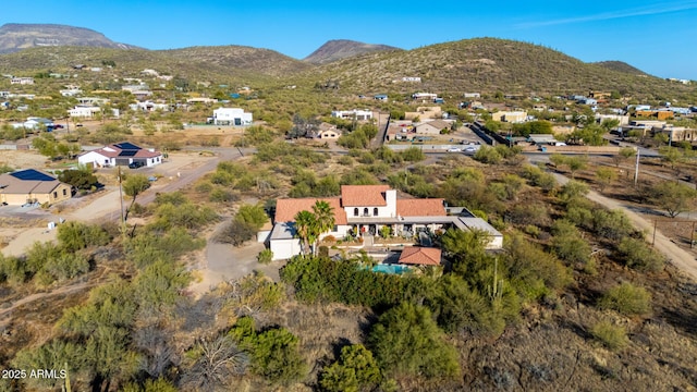 birds eye view of property with a mountain view