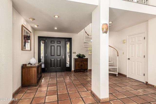 entryway with light tile patterned floors, baseboards, stairs, and recessed lighting