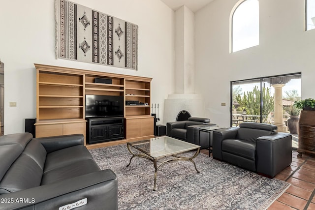 living room featuring a high ceiling and tile patterned floors