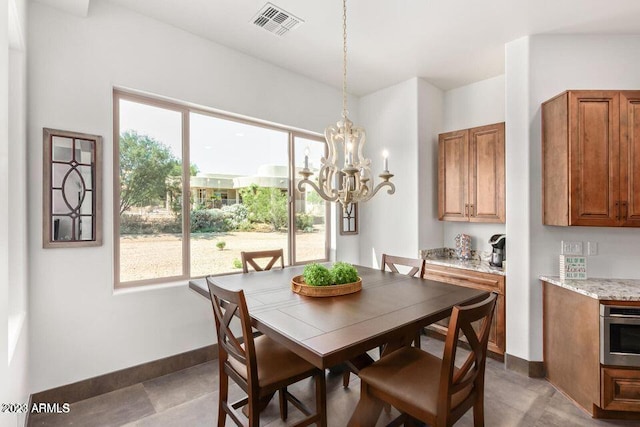 dining area featuring an inviting chandelier