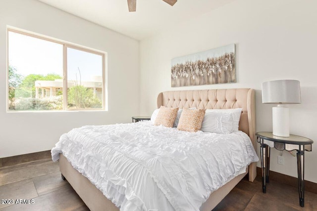bedroom with dark tile patterned flooring and ceiling fan