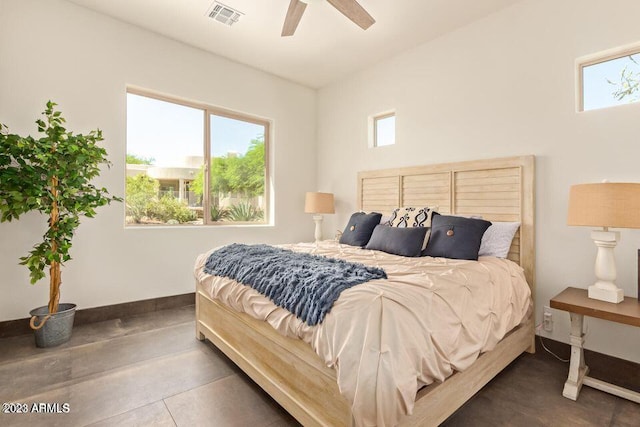 tiled bedroom featuring multiple windows and ceiling fan