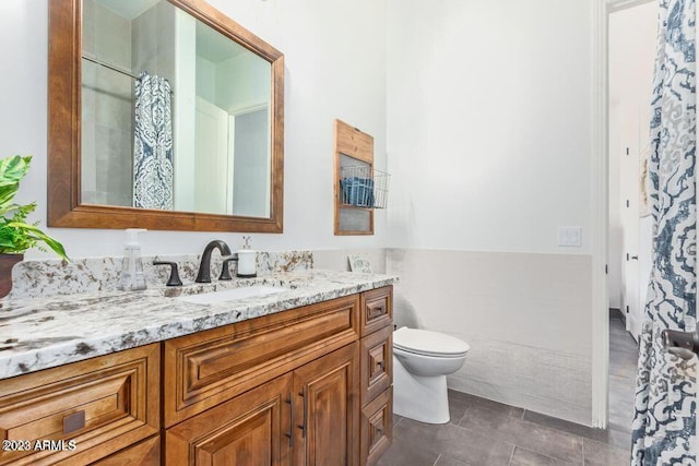 bathroom featuring a shower with shower curtain, vanity, toilet, and tile patterned flooring