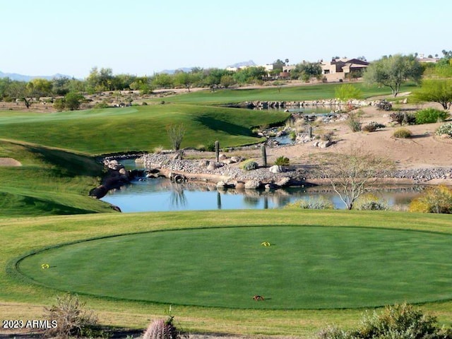 surrounding community with a yard and a water view