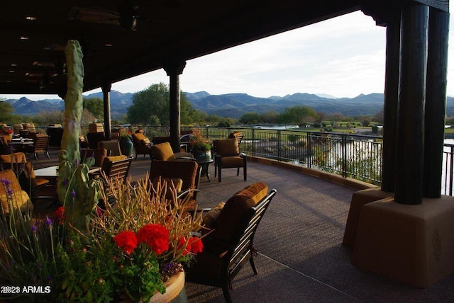 view of patio / terrace featuring a water and mountain view
