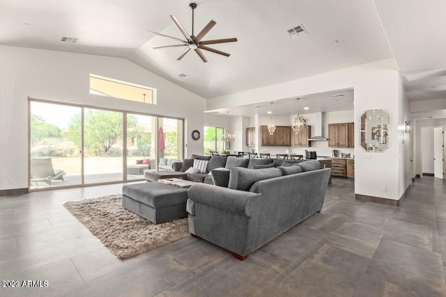 tiled living room with ceiling fan and high vaulted ceiling