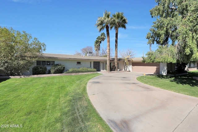 ranch-style home with a front yard, concrete driveway, and an attached garage