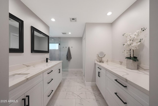 bathroom featuring visible vents, double vanity, a stall shower, marble finish floor, and a sink