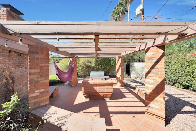 view of patio featuring grilling area, an outdoor kitchen, and a pergola