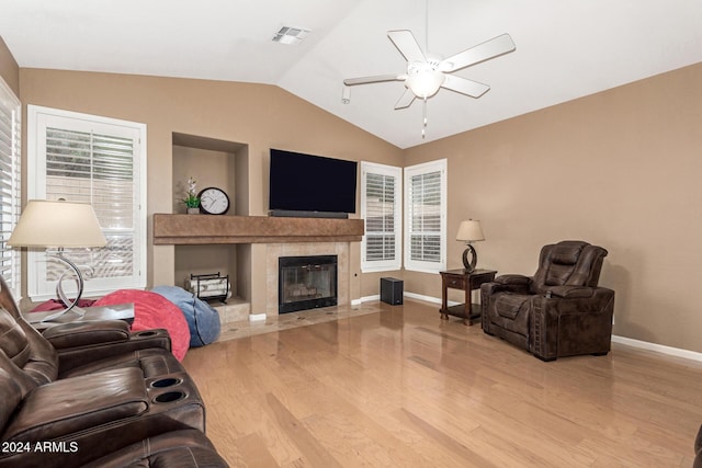 living room with light wood-type flooring, plenty of natural light, and lofted ceiling