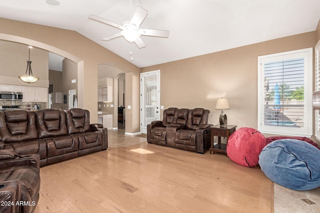 living room featuring light hardwood / wood-style floors, ceiling fan, and lofted ceiling