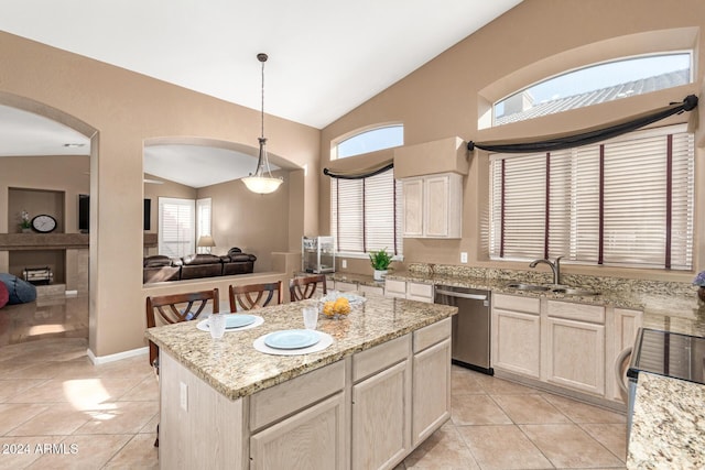 kitchen with dishwasher, a center island, lofted ceiling, sink, and light tile patterned floors