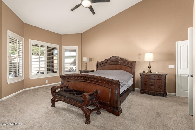 carpeted bedroom featuring ceiling fan and vaulted ceiling