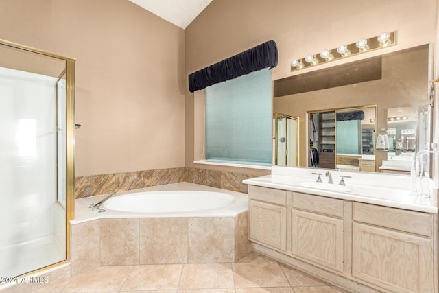 bathroom with tile patterned floors, vanity, and shower with separate bathtub