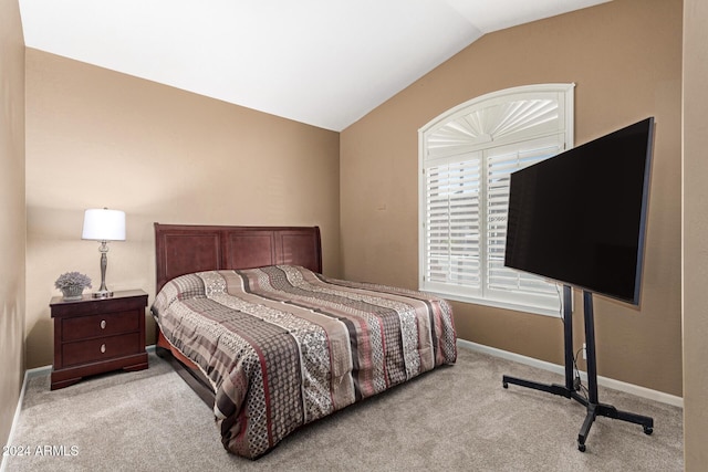 carpeted bedroom with vaulted ceiling