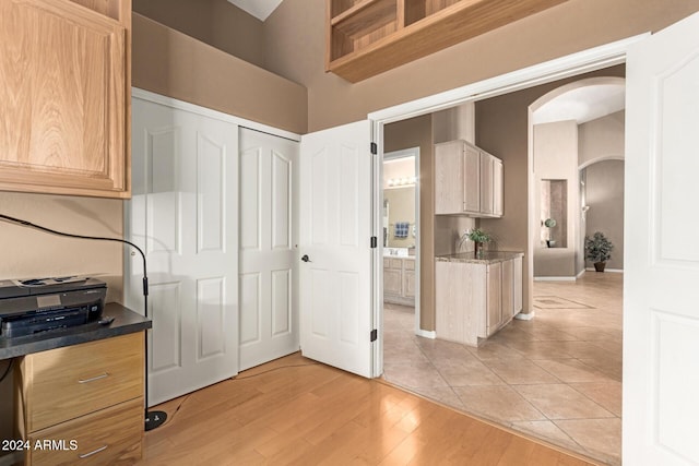 kitchen with light brown cabinetry and light hardwood / wood-style flooring