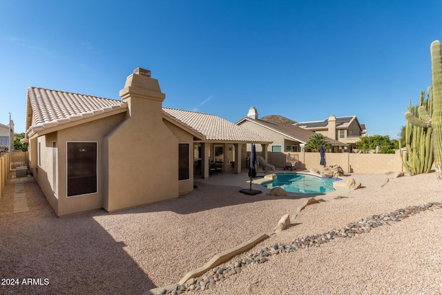 back of house with a patio area and a fenced in pool