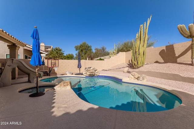 view of pool featuring a patio area and an in ground hot tub