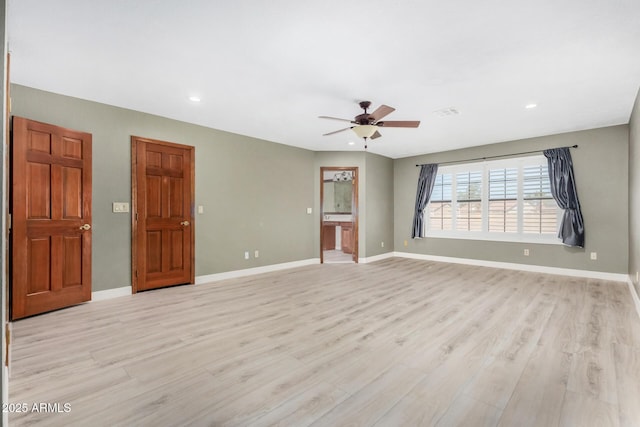 spare room featuring recessed lighting, light wood-type flooring, a ceiling fan, and baseboards