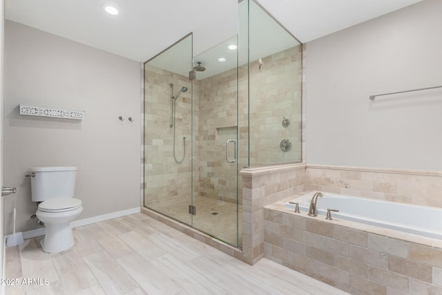 full bathroom featuring baseboards, a shower stall, toilet, and a bath