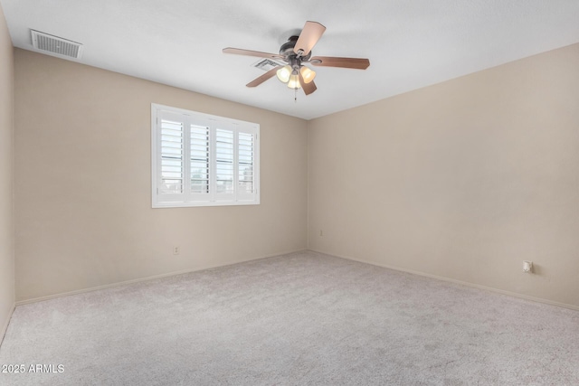 unfurnished room featuring light carpet, visible vents, and a ceiling fan