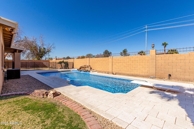 view of pool featuring a diving board, a patio area, a fenced backyard, and a fenced in pool