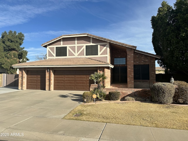 view of front of home featuring a garage, brick siding, driveway, and a tiled roof