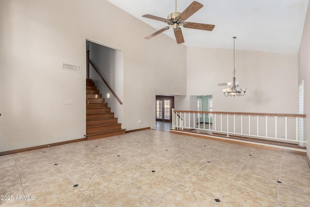 empty room with high vaulted ceiling, visible vents, stairway, and baseboards