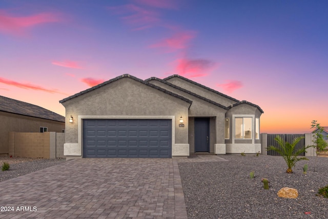 8541 W Reventon Dr, Arizona City, AZ 85123 - ranch-style house with a tile roof, stucco siding, fence, decorative driveway, and a garage