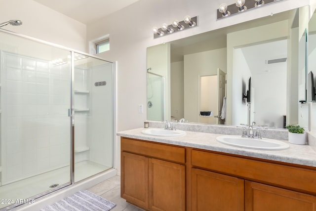 bathroom with vanity, tile patterned floors, and a shower with door