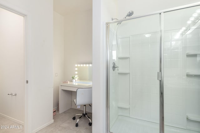 bathroom featuring tile patterned floors and a shower with shower door