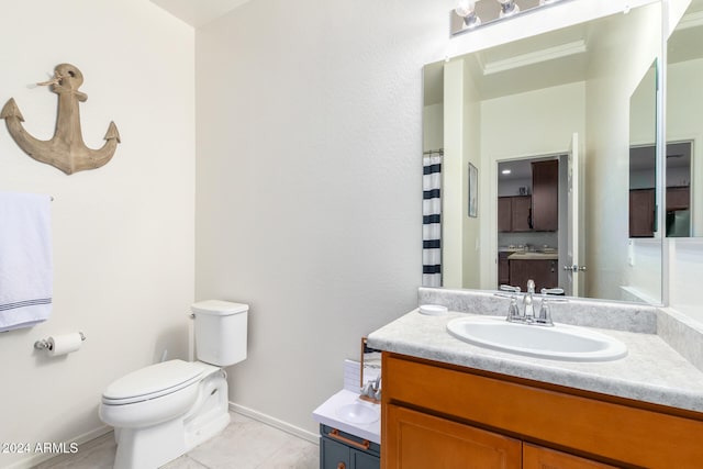 bathroom with tile patterned flooring, vanity, and toilet