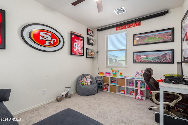 carpeted office space with ceiling fan