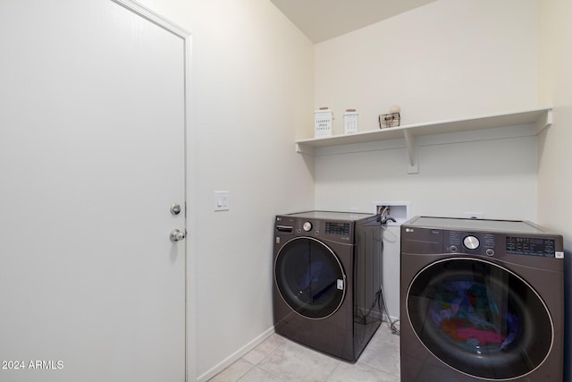 laundry room with light tile patterned floors and washer and dryer