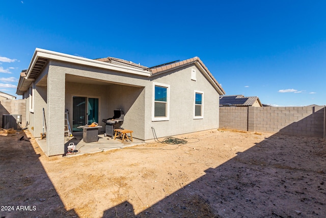 back of house featuring cooling unit and a patio