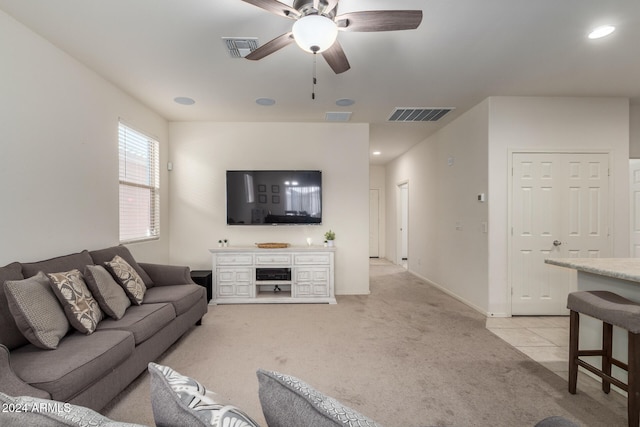 carpeted living room with ceiling fan