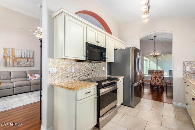 kitchen featuring backsplash, pendant lighting, stainless steel appliances, and light wood-type flooring